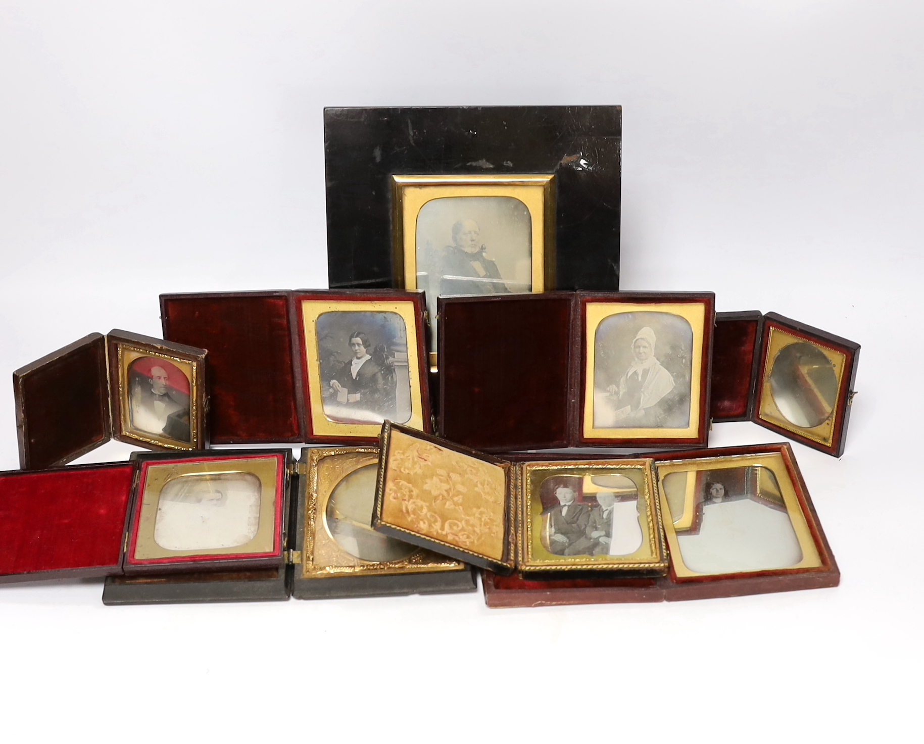 Nine mid 19th century daguerreotype portrait photographs, all mounted in brass, etc. frames, some in decorative cases, one example framed